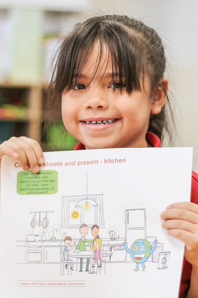 girl holding sustainability teaching materials